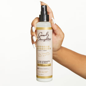 Carol's Daughter bottle held in hand illustrating 8.5 fl oz size for travel planning