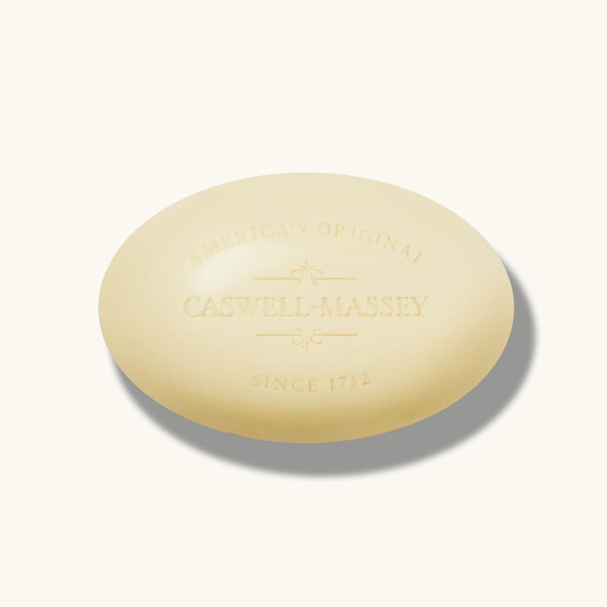 Lifestyle bathroom shelf with Caswell-Massey bars styled near towel, suggesting elegant daily grooming