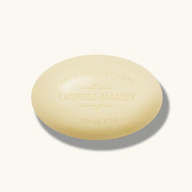 Lifestyle bathroom shelf with Caswell-Massey bars styled near towel, suggesting elegant daily grooming
