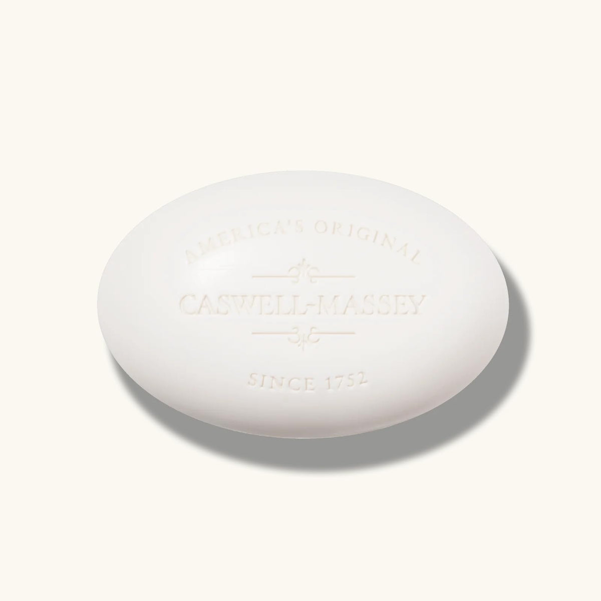 Caswell-Massey bar next to ruler size comparison for clear weight and scale