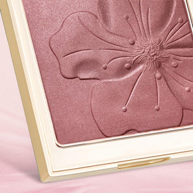 Model applying Catkin blush on cheeks for natural, long-lasting flush