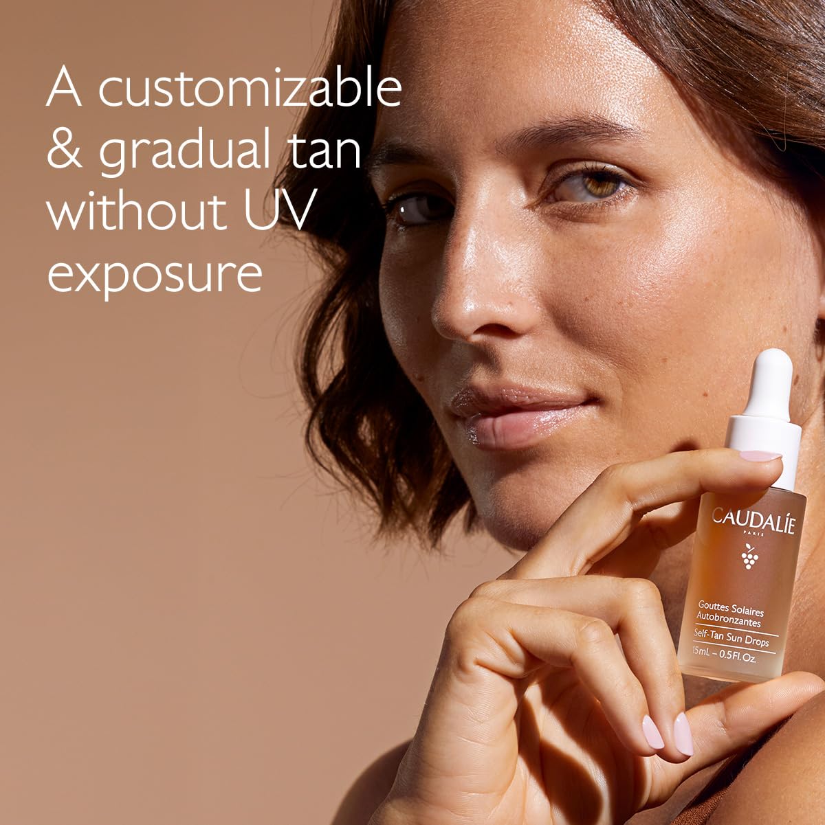 Close-up pipette dispensing Caudalie drops for precise customized dosing