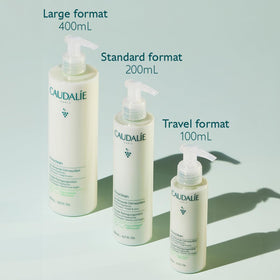200 mL Caudalie bottle in hand to demonstrate true product scale