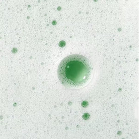 Caudalie cleanser mixed with exfoliator showing creamy whipped texture for gentle exfoliation