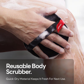 CAVEEM scrubber next to hand for scale showing compact travel-friendly size