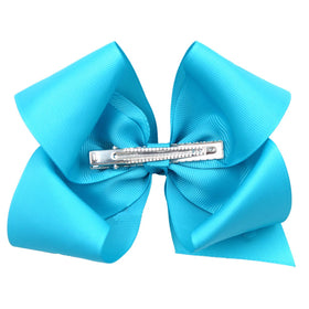 CÉLLOT bow next to ruler showing 6-inch scale for size clarity
