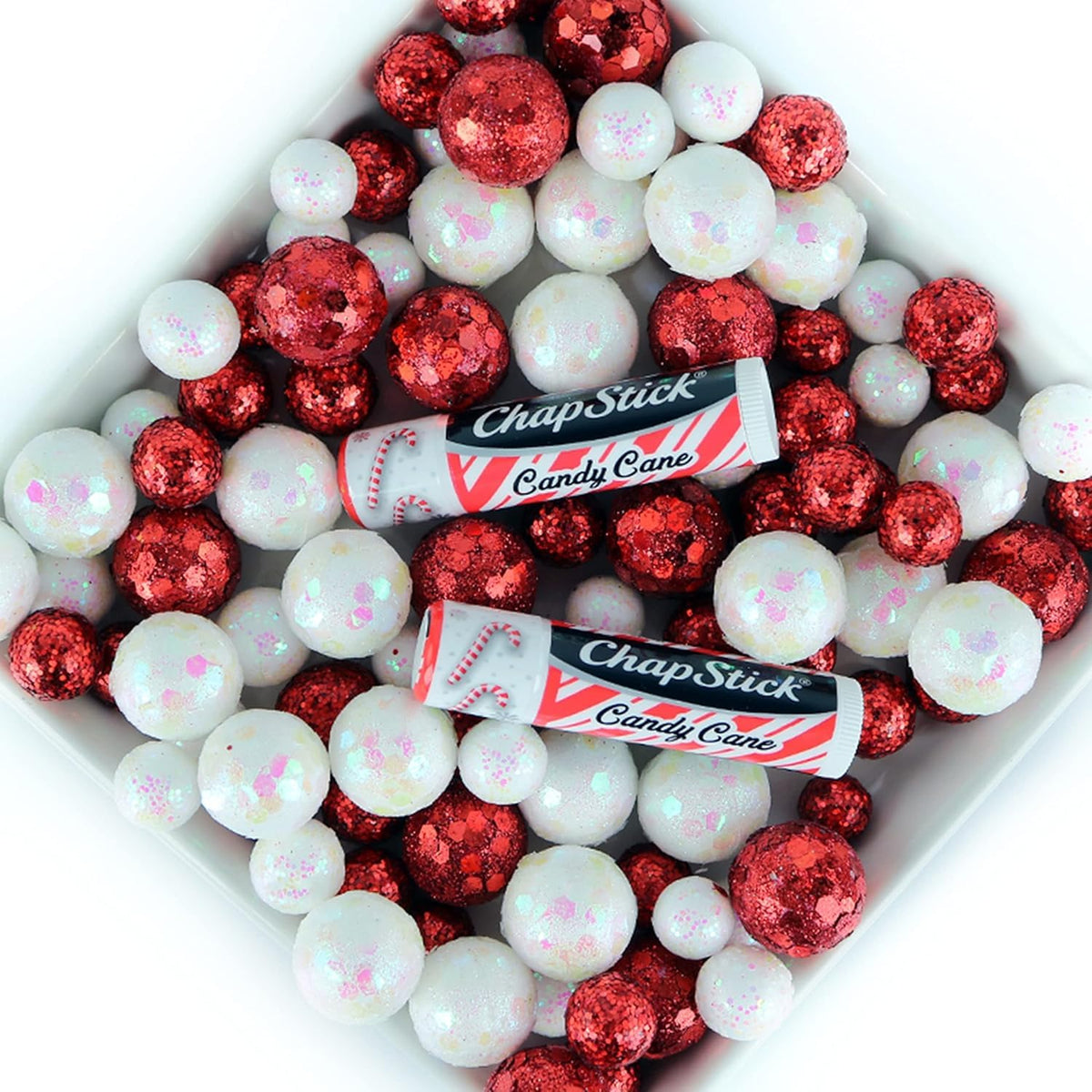 ChapStick Candy Cane held in hand to show compact size and pocket-ready portability