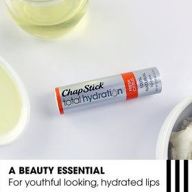 ChapStick Total Hydration next to a coin showing portable 0.12 oz size and travel convenience