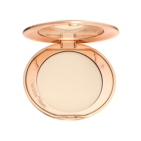 Charlotte Tilbury compact front view showing sleek packaging and travel ready benefit