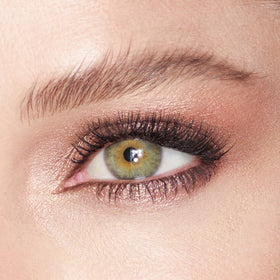 Charlotte Tilbury model applying Oyster Pearl with finger for instant radiance