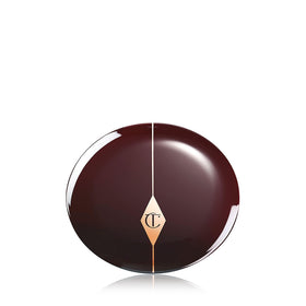 Charlotte Tilbury blush application lifestyle scene showing glowing cheeks and natural radiance