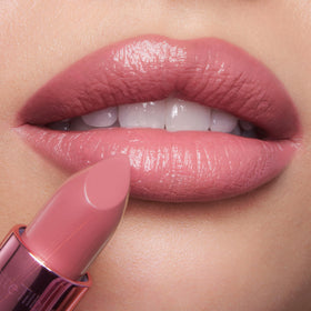 Charlotte Tilbury candy chic lipstick swatch highlighting texture and luminous light-diffusing pigments