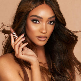 Charlotte Tilbury flatlay with Catwalking and makeup suggesting styling versatility