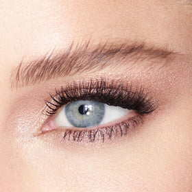 Charlotte Tilbury Champagne shade on model eyelid demonstrating luminous, eye-brightening effect