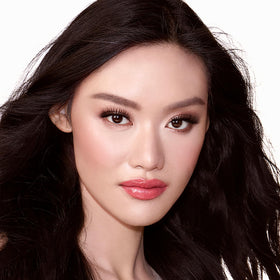 Charlotte Tilbury blush applied on cheek demonstrating luminous glow benefit