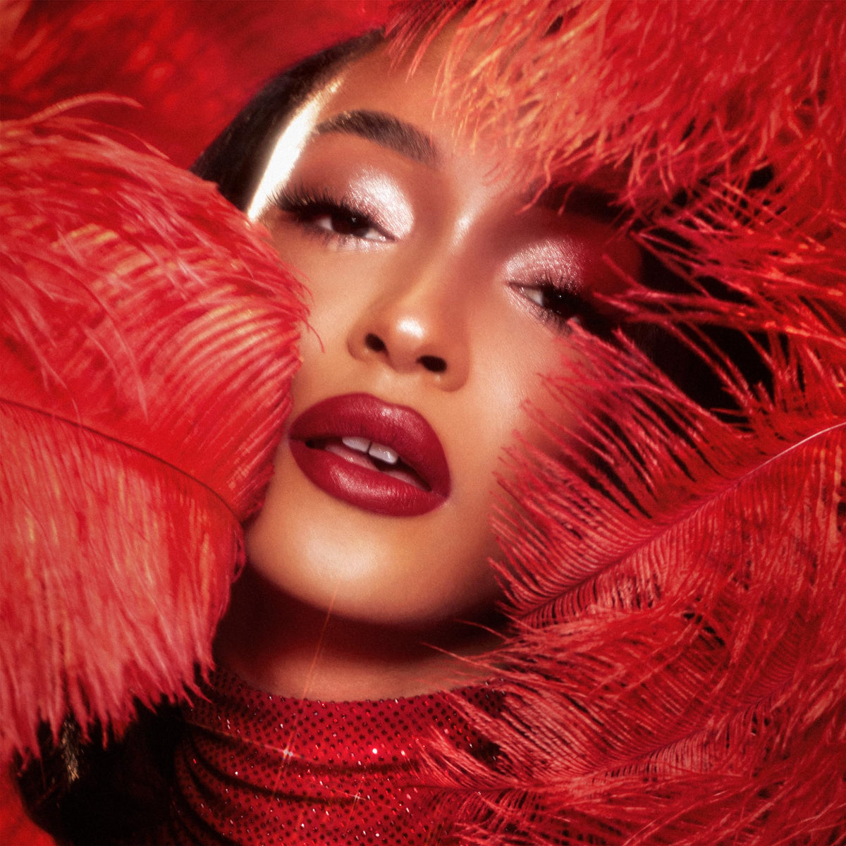 Charlotte Tilbury lipstick applied on model lips demonstrating vivid cherry-red payoff