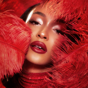 Charlotte Tilbury lipstick applied on model lips demonstrating vivid cherry-red payoff