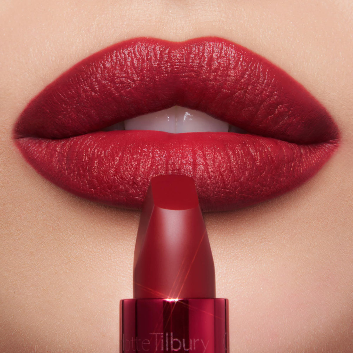 Charlotte Tilbury red metallic tube opened displaying lipstick and premium casing