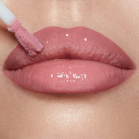 Charlotte Tilbury gloss worn by model closeup, shows cool-pink Pillow Talk Fair flattering glow