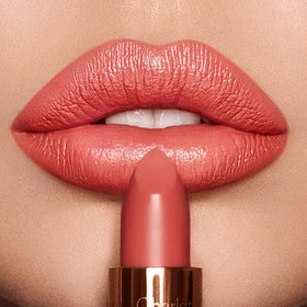 Charlotte Tilbury Coral Kiss texture swirl of lipstick showing creamy, hydrating finish for soft lips