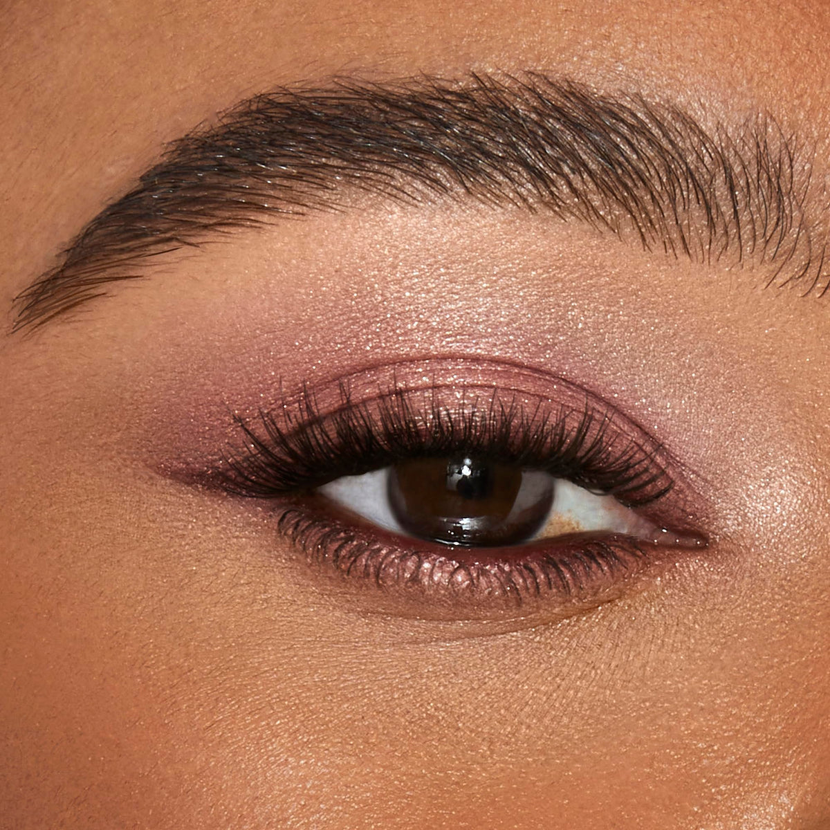 Charlotte Tilbury application with fingertip patting Pillow Talk for quick, luminous eye color