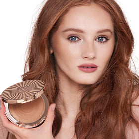 Charlotte Tilbury model showing face and neck with sun-kissed glow benefit