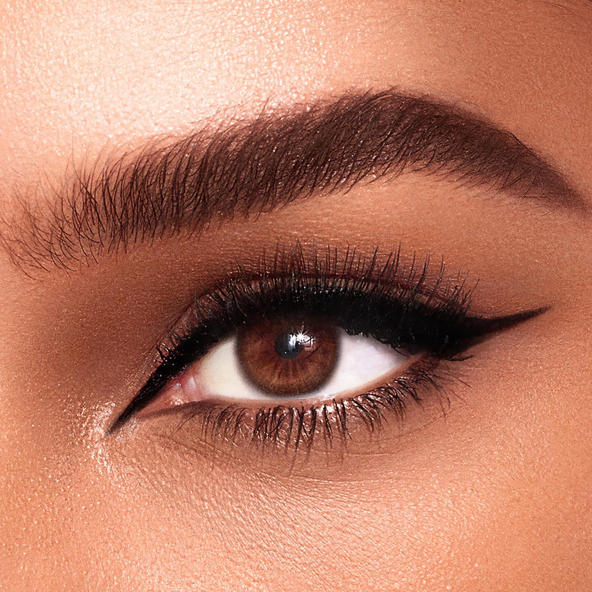 Charlotte Tilbury Feline Flick application in use demonstrating smooth wing creation and long-wear benefit