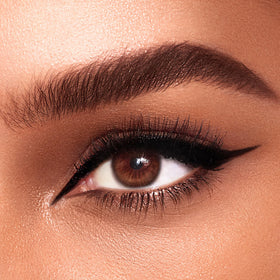 Charlotte Tilbury Feline Flick application in use demonstrating smooth wing creation and long-wear benefit