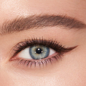 Charlotte Tilbury swatch on arm demonstrating rich Super Brown pigment payoff