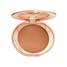 Charlotte Tilbury compact front view showing elegant packaging and travel convenience