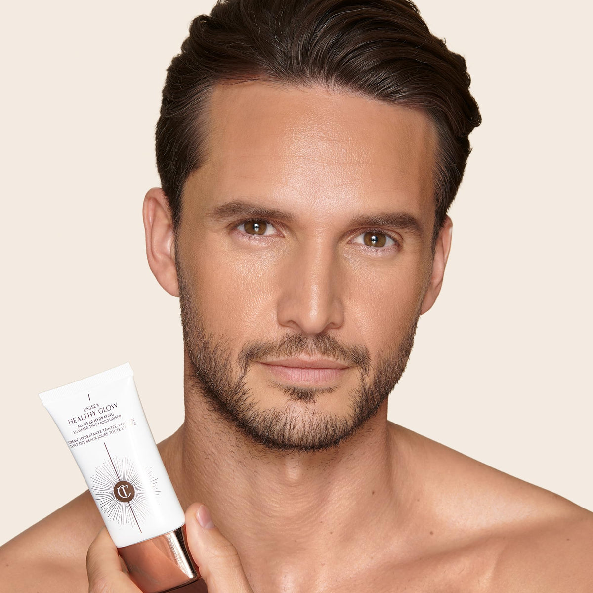 Charlotte Tilbury bottle next to common items for scale, clarifies travel‑friendly size