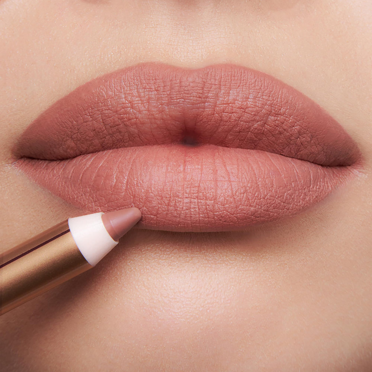 Charlotte Tilbury in-use image applying liner to lips for natural shaping