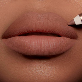 Charlotte Tilbury lip cheat applied on lips creating defined fuller-looking pout