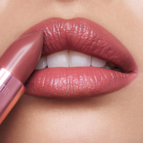 Charlotte Tilbury close-up of lipstick texture highlighting satin finish and light-diffusing pigments benefit: luminous look