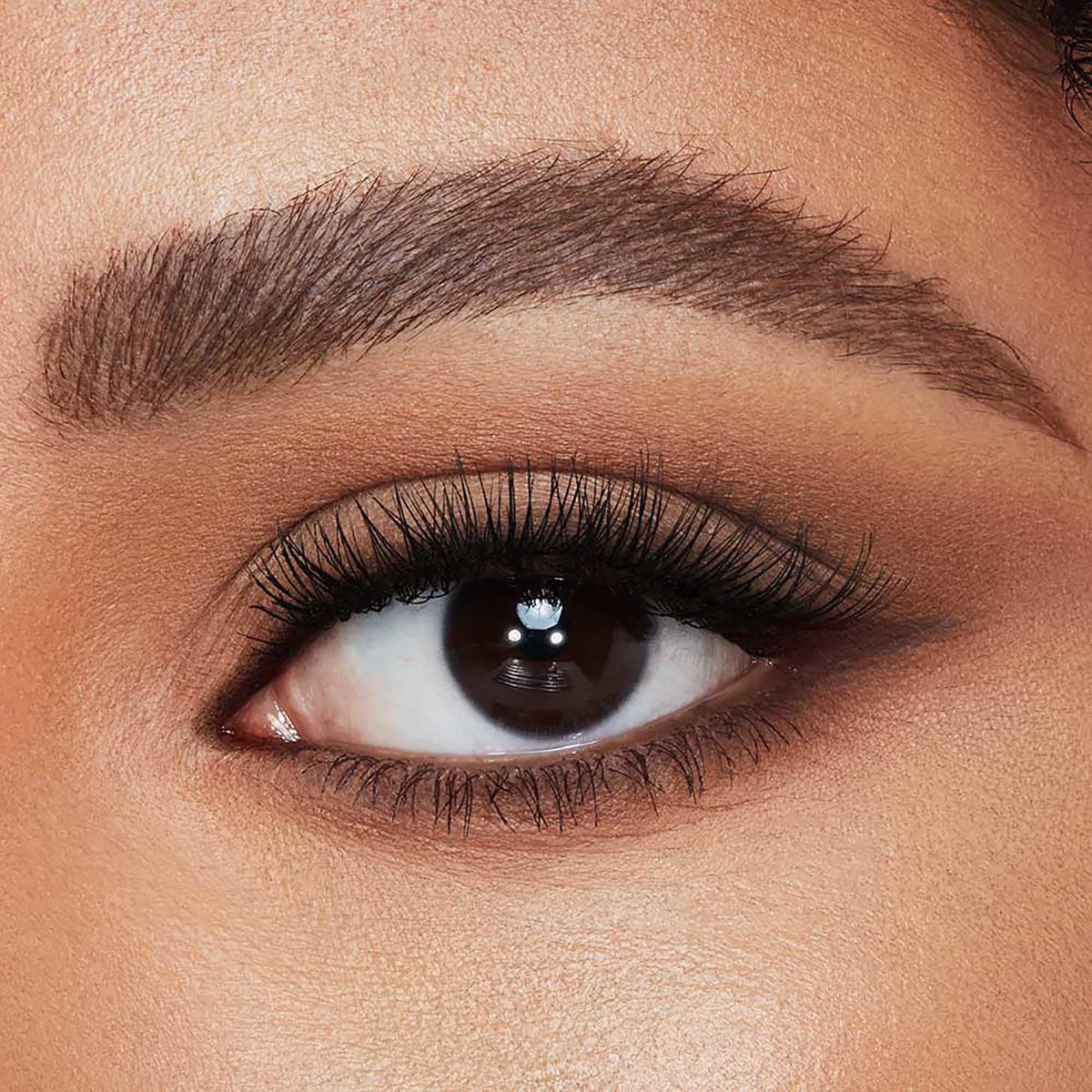 Charlotte Tilbury tube next to hand to show compact size and travel-friendly convenience