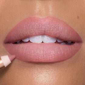 Charlotte Tilbury lip liner next to matching lipstick showing coordinated color benefit