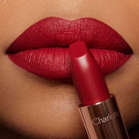 Charlotte Tilbury on-model wearing Red Carpet Red showing glamorous finish benefit: camera-ready look