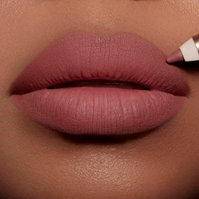 Charlotte Tilbury lip application demo creating a fuller-looking, defined pout