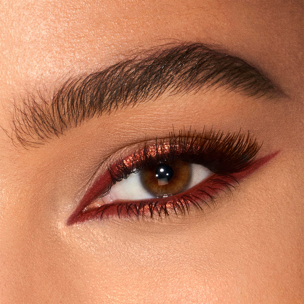 Charlotte Tilbury swatch showing creamy copper texture and blendability for visible dimension