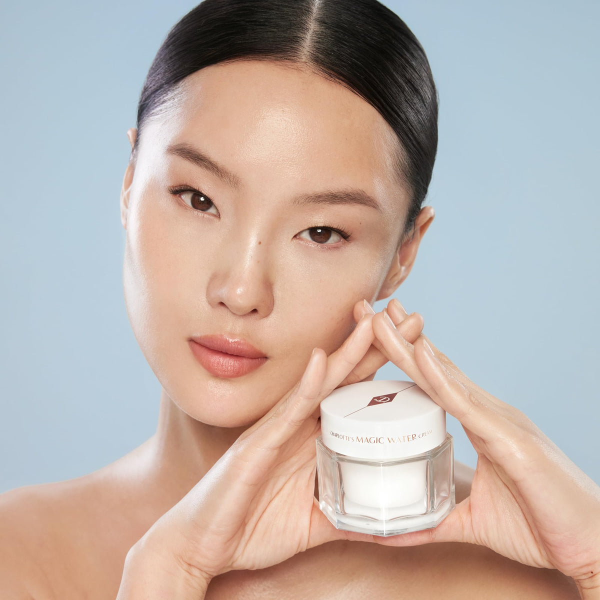 Charlotte Tilbury jar styled on bathroom shelf for daily routine convenience
