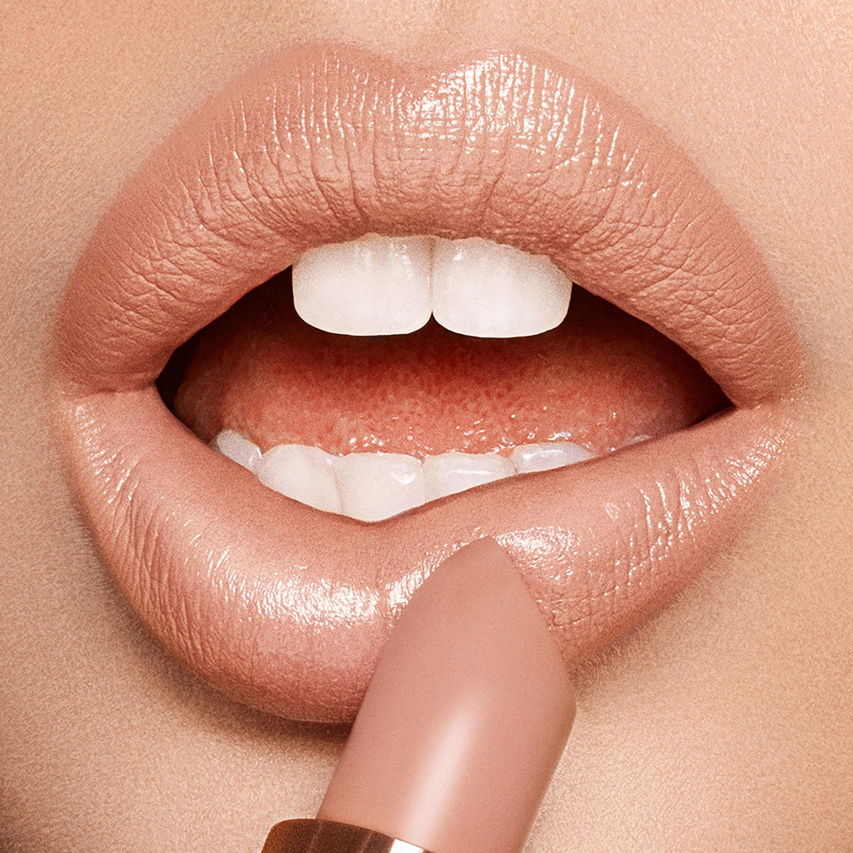Charlotte Tilbury Nude Kate held in hand to show true-to-size scale and portability