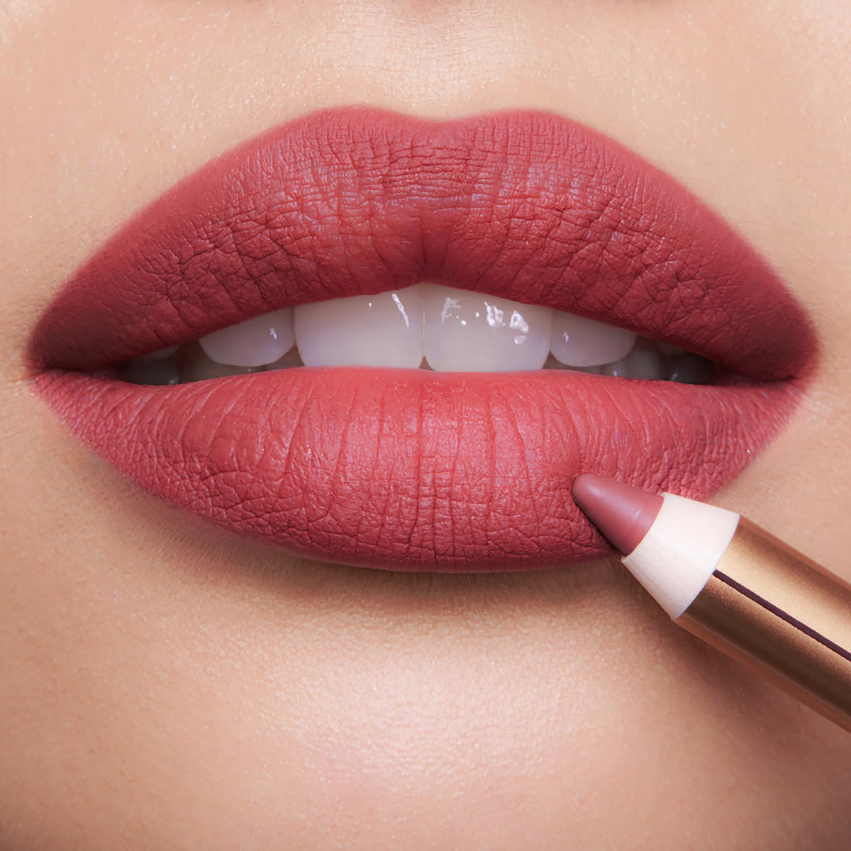 Charlotte Tilbury pencil held in hand showing true size and portability