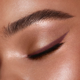 Charlotte Tilbury eyeliner with packaging in a vanity scene for effortless style