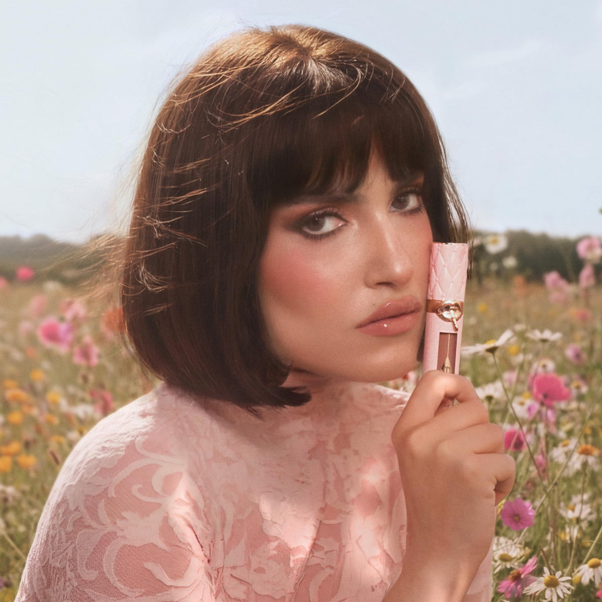 Charlotte Tilbury vanity lifestyle image with gloss near mirror showing polished, confidence-boosting result