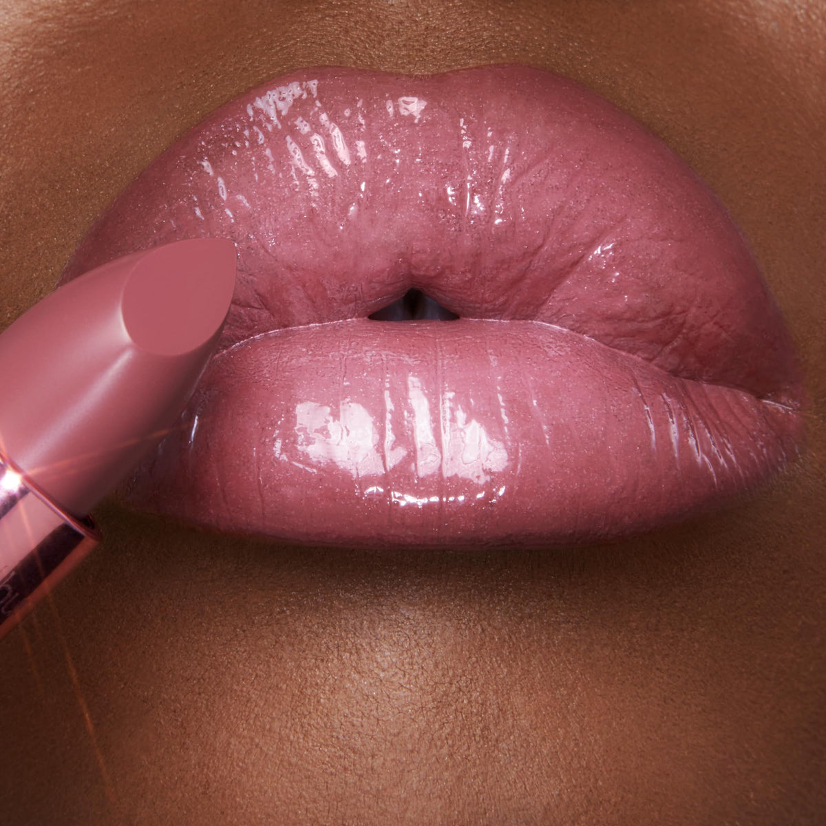Charlotte Tilbury lip swatch on hand demonstrating buildable color and hydrating sheen