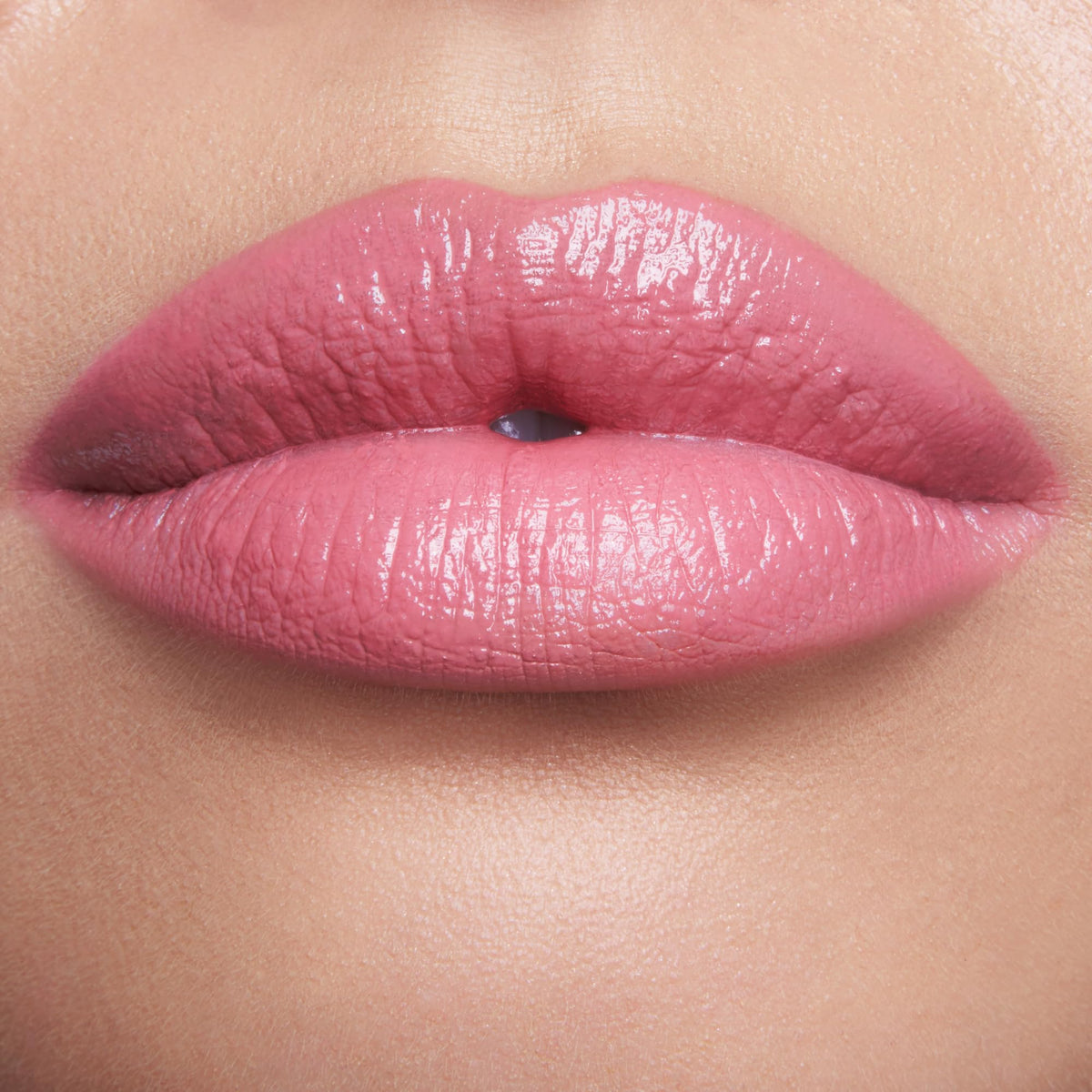 Charlotte Tilbury texture swipe of Red Carpet Pink showing creamy moisturizing finish