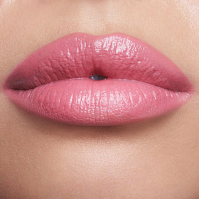 Charlotte Tilbury texture swipe of Red Carpet Pink showing creamy moisturizing finish