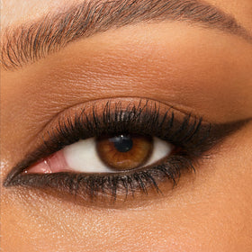 Charlotte Tilbury arm swatch of Barbarella Brown showing rich pigment