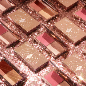 Charlotte Tilbury compact beside credit card illustrating pocket-friendly size