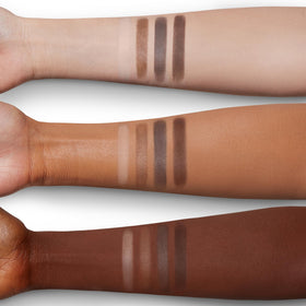 Charlotte Tilbury palette scale next to hand showing compact size for travel convenience